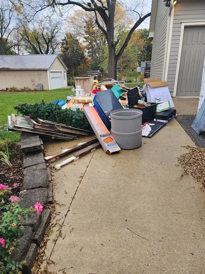 Dumpster being loaded with debris for Residential Dumpster Rental in Arvada